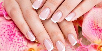 Beautiful woman's nails with beautiful french manicure