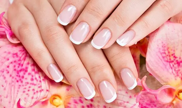 Beautiful woman's nails with beautiful french manicure